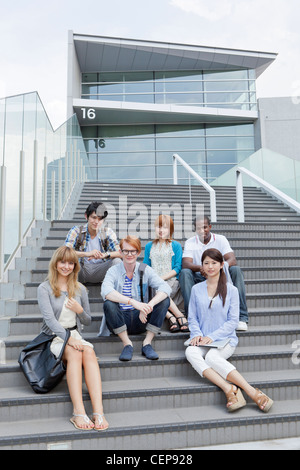 University students sitting on steps Stock Photo
