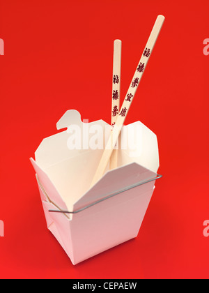 A Chinese takeaway container isolated against an orange background Stock Photo