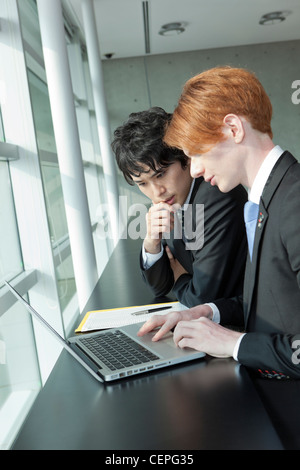 Two businessmen working with laptop Stock Photo