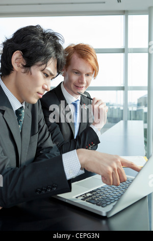 Two businessmen working with laptop Stock Photo