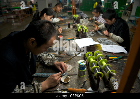 Employees molding fashion jewelry in Zhejiang Neoglory Jewelry Co., Ltd. in Yiwu, Zhejiang, China.  07-Nov-2011 Stock Photo