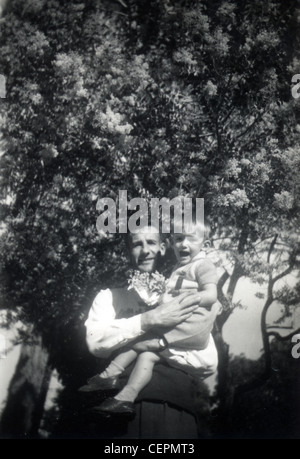 Archive Photo: Father and son by a tree (c1945) Stock Photo
