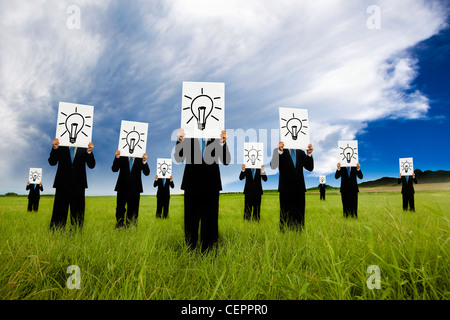 group of business man holding bulb symbol. business idea and solution concept Stock Photo
