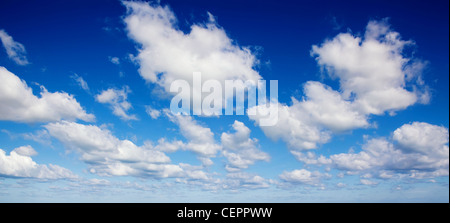 Dynamic clouds in blue sky over the sea Stock Photo