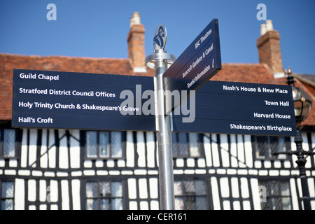 A tourist information signpost in Stratford-upon-Avon in front of a medieval half-timbered house. Stock Photo