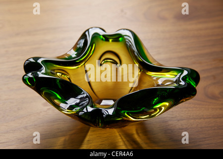 green and yellow glass ashtray for cigars or cigarettes Stock Photo