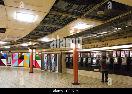 Public telephones at Piccadilly Circus underground station. The station is one of the few stations which have no associated buil Stock Photo