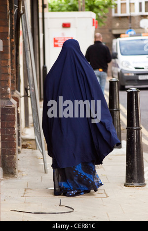 Worshipper going to the mosque in Whitechapel. Mosques originated on the Arabian Peninsula as places for worship and prayer. Stock Photo