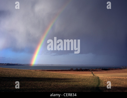 Rainbow and stormy sky over the river Stour near Mistley. Stock Photo