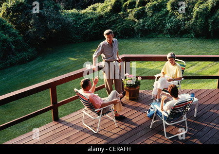 Two Couples Socializing on  Suburban Deck Stock Photo