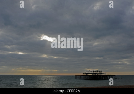 Shaft of light breaking through the dark clouds on to the sea by the West Pier Brighton UK Shaft of light breaking through the dark clouds on to the sea by the West Pier Brighton UK