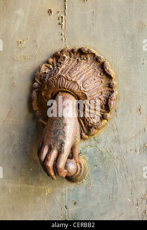 Rusted Hand Door Knocker Stock Photo