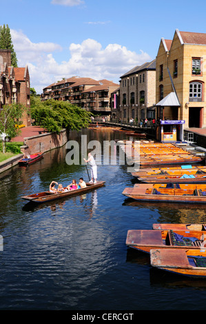 Tourists punting on the River Cam in the Quayside area of Cambridge near Magdalene Bridge.