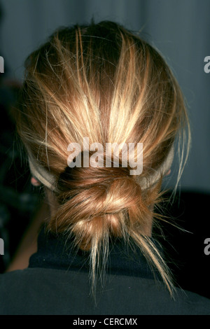 Burberry Milan Backstage Spring Summer Back view of model long blonde hair pulled back off face tied into knot at nape of neck Stock Photo