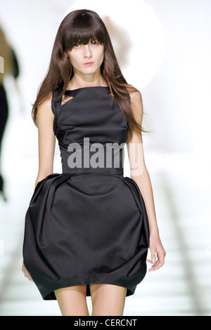 Preen London Ready to Wear Spring Summer Canadian Romanian model Irina Lazareanu wearing sleeveless black satin puffball dress Stock Photo