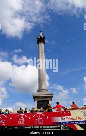 Tourists on an open-top sightseeing tour bus at Nelson's Column in Trafalgar Square. Stock Photo