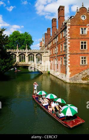 Tourists enjoying a trip along the River Cam by the Bridge of Sighs in a punt at St Johns College. Stock Photo