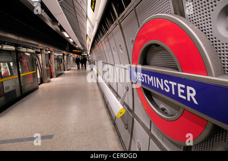 A tube train alongside a platform on the Jubilee line at Westminster Underground Station. Stock Photo