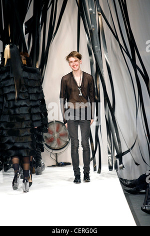 Gareth Pugh London Ready to Wear Autumn Winter Designer Gareth Pugh wearing black seethrough top and very tight grey jeans Stock Photo