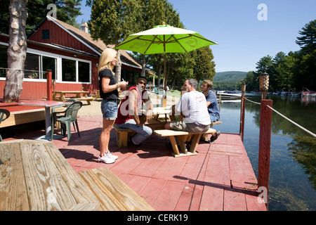 A waitress takes orders from customers at a lakeside bar and grill in Canaan, NY. Stock Photo