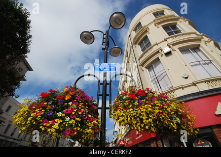 colorful street corner with flower boxes Eastbourne United Kingdom Stock Photo