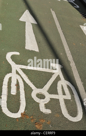 A white cycle graphic painted on a road indicating a cycle lane. Stock Photo