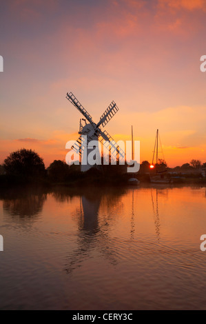 A view toward Thurne drainage mill on the River Thurne. Stock Photo