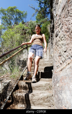 A young woman walking down steep steps in the Blue Mountain, Australia Stock Photo