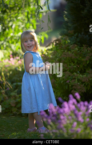 child (young girl) in garden, Dorset, England, UK Stock Photo