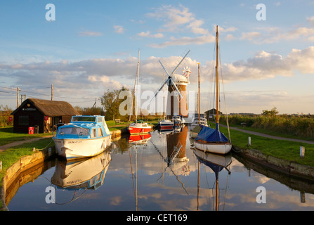 Horsey Windmill and boats moored at Brancaster Staithe in Norfolk. Stock Photo