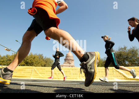 Runners pass by the Texas Capitol as more than 18,000 runners pounded the streets of downtown Austin for annual marathon race Stock Photo