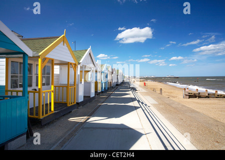 A row of colourful beach huts on the seafront at Southwold on a summers day on the Suffolk Coast. Stock Photo