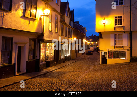 Elm Hill, an historic cobbled lane featuring many buildings from the Tudor period, illuminated at dusk. Stock Photo