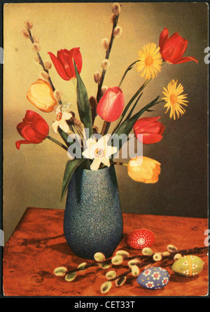 GERMANY - CIRCA 1964: Postcard printed in GDR, shows the tulips in a vase and painted eggs, circa 1964 Stock Photo