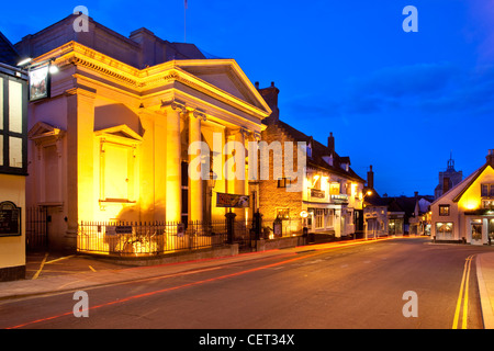 A light trail from a car passing Diss Corn Hall, an arts centre and venue in the town centre at dusk. Stock Photo