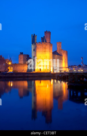Caernarfon Castle at the mouth of the Seiont river at dusk. Stock Photo