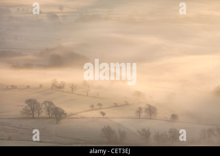 The Hope Valley shrouded in mist at dawn in the Peak District National Park. Stock Photo