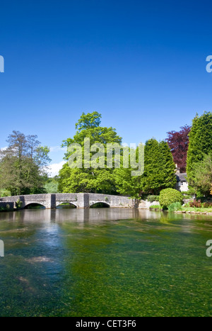 The low arched medieval Sheepwash Bridge over the River Wye at Ashford in the Water in the Peak District National Park. Stock Photo