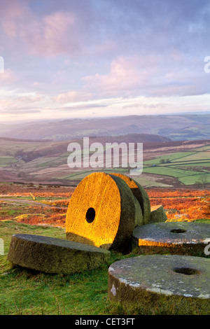 Abandoned millstones beneath Stanage Edge at first light in the Peak District National Park. Stock Photo