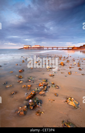 Stormy light over Cromer Pier shortly before sunset on the North Norfolk Coast. Stock Photo