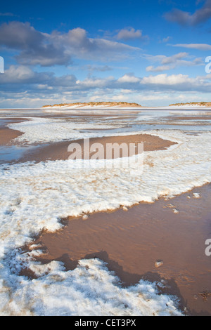 Snow left on the beach from the incoming tide at Wells-next-the-Sea on the North Norfolk Coast. Stock Photo