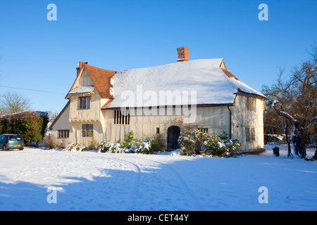 Snow on and around Valley Farm, a medieval Hall House built in the 15th century. It is the oldest building in Flatford. Stock Photo