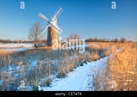 Snow on the ground around the newly restored Hardley Drainage Mill, originally built in 1874, on the Norfolk Broads. Stock Photo