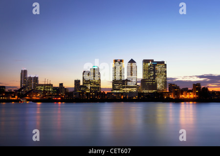 Canary Wharf at Dusk, stitch panoramic of Canary Wharf the light coming on and reflecting in the Thames. Stock Photo