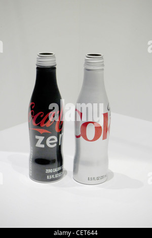 Two sleek, aluminum Coca-Cola bottles—one black "Coca-Cola Zero" and one silver "Diet Coke"—standing side-by-side against a clean, white minimalist ba Stock Photo