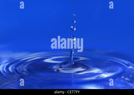 Water drops falling creating ripples Stock Photo