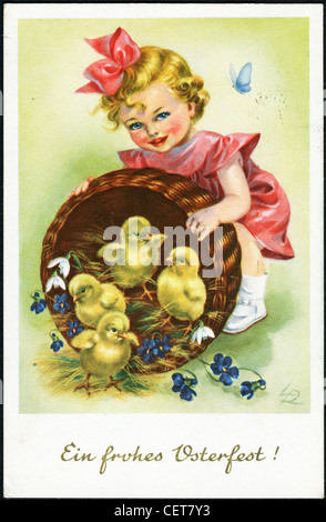 Easter postcard printed in Austria, shows a little girl with a basket, and the chicks, circa 1957. German Text: Happy Easter! Stock Photo