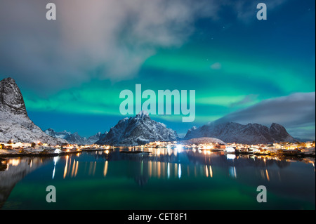Northern Lights - Aurora Borealis fill night sky over Reine, Lofoten Islands, Norway Stock Photo