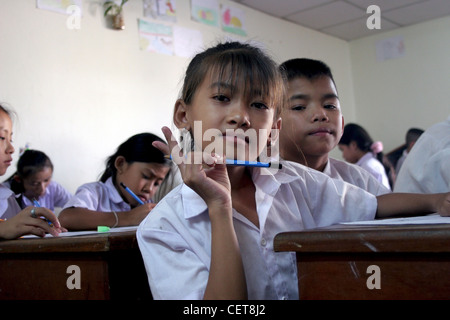 A 10 year old deaf girl is signing with her hand during an art class at the National Rehabilitation Center in Vientiane, Laos. Stock Photo