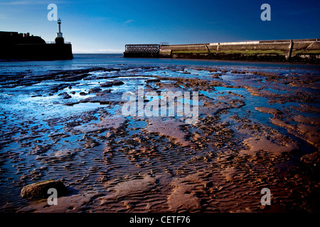 A view from the muddy banks of Maryport Harbour. Stock Photo